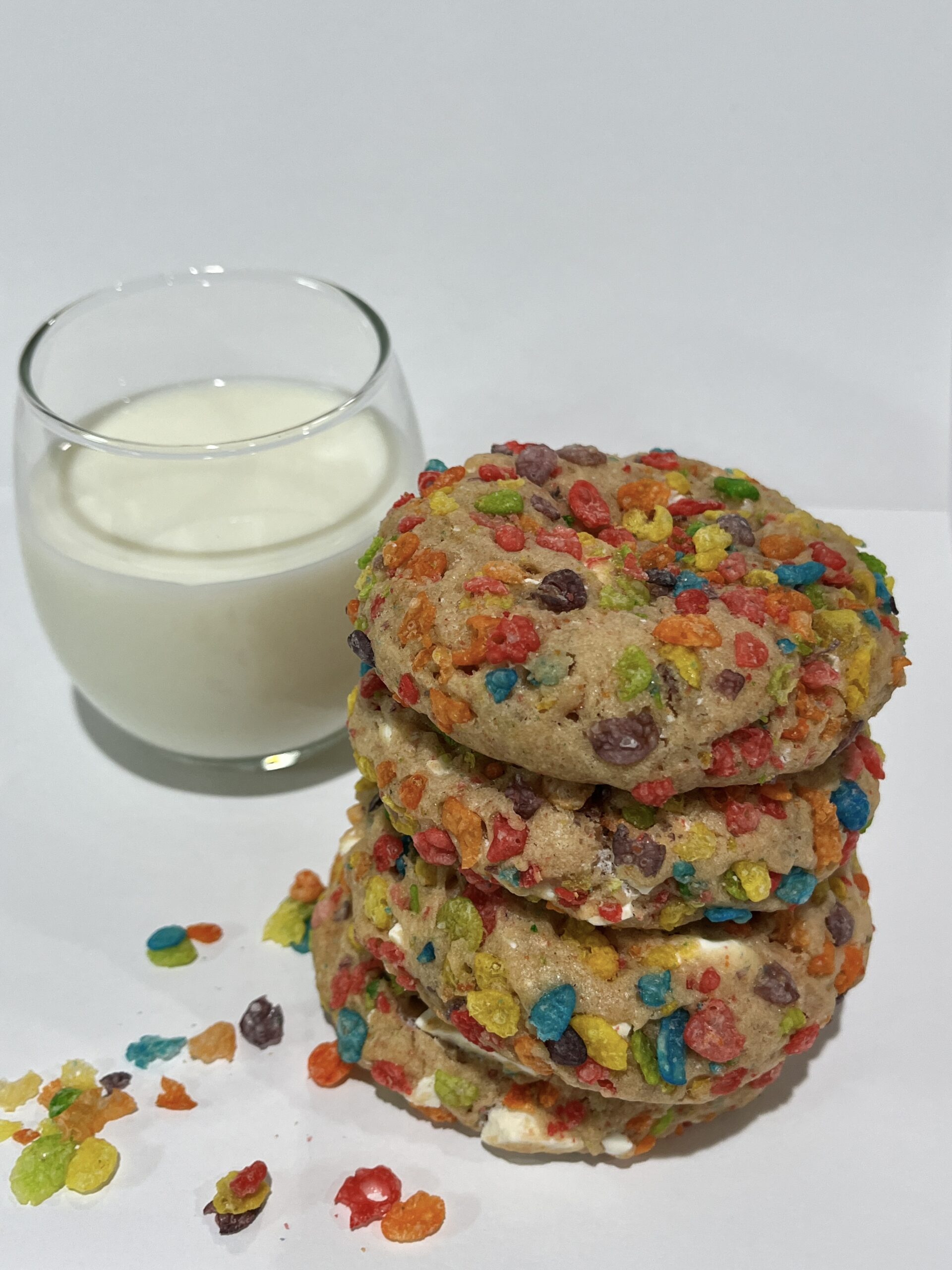 Close-up of a fruity pebble cookie with melted chocolate chips and a gooey marshmallow center, soft-baked and topped with colorful cereal pieces, perfect for birthday parties, fun bakery treats, or nostalgic dessert lovers.