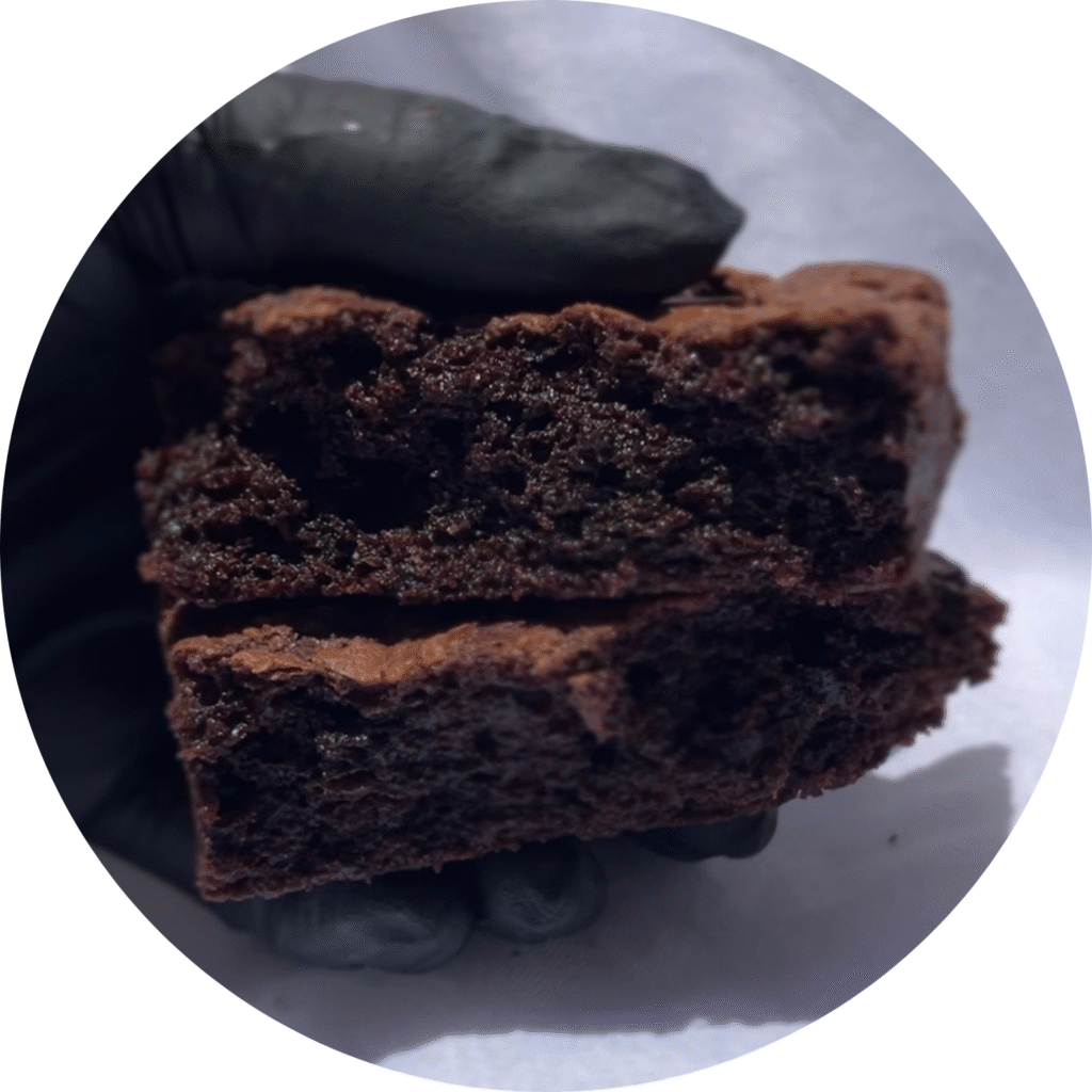 "cross‑section of fudgy chocolate brownie with crackly top and gooey center"