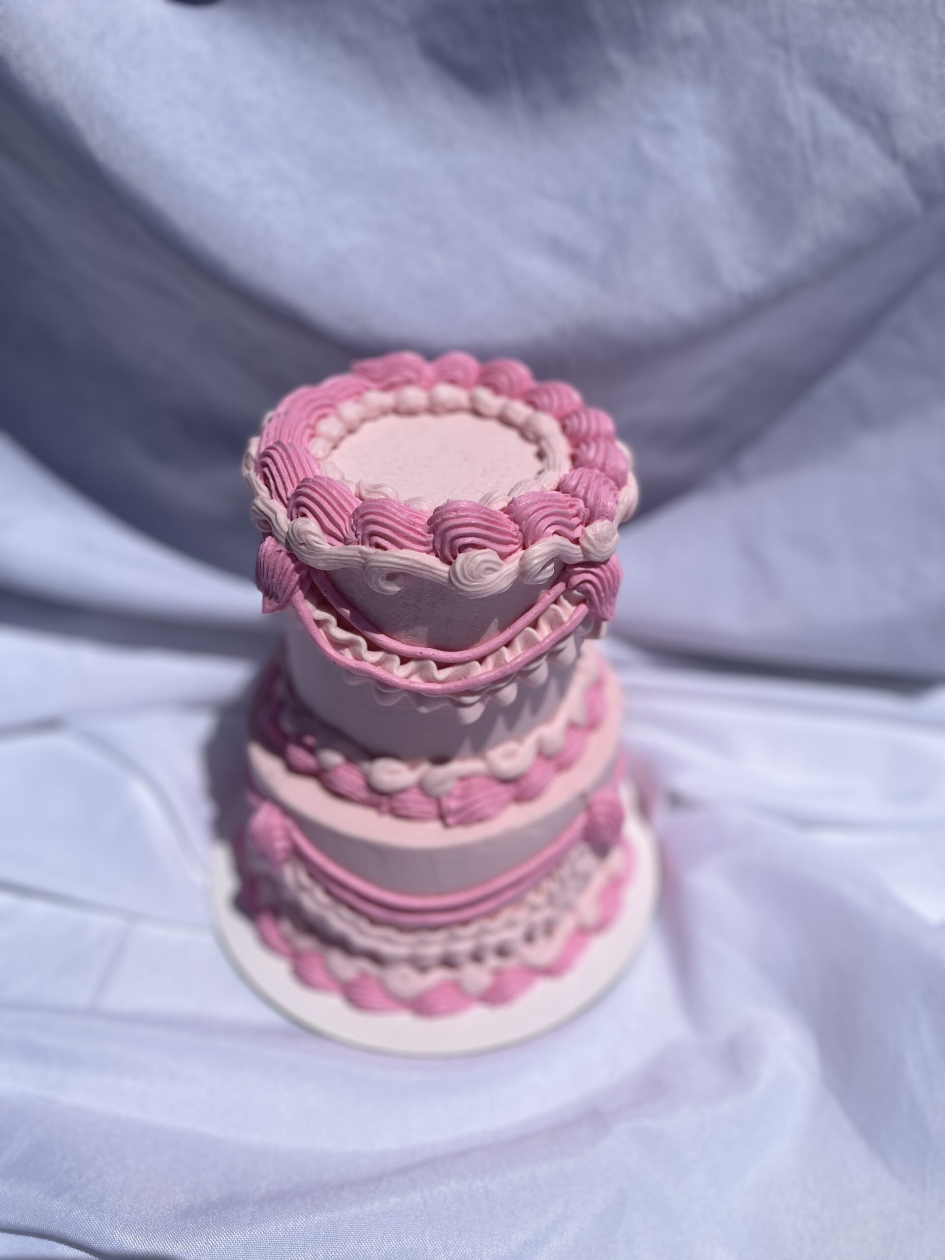 two tier pink vintage inspired coquette cake top view pink elegant piping for feminine celebration